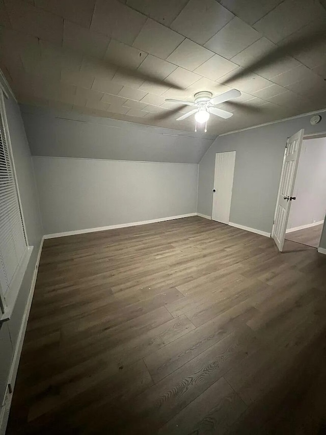 939 Baraga St NE, Grand Rapids, MI 49503 - bonus room with dark wood-type flooring, a ceiling fan, lofted ceiling, and baseboards