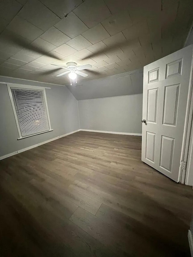 939 Baraga St NE, Grand Rapids, MI 49503 - bonus room featuring a ceiling fan, baseboards, dark wood-type flooring, and lofted ceiling