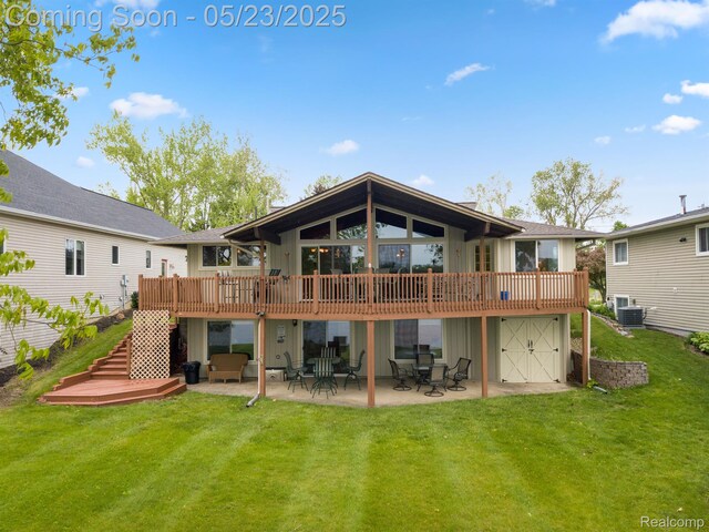 13953 Grandpoint Dr, Cement City, MI 49233 - back of house featuring a patio area, a lawn, stairway, and a wooden deck
