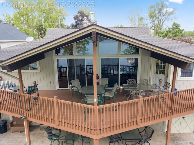 13953 Grandpoint Dr, Cement City, MI 49233 - back of house with outdoor dining area, a shingled roof, a wooden deck, and a chimney