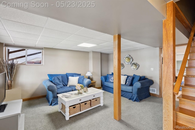 13953 Grandpoint Dr, Cement City, MI 49233 - carpeted living area featuring stairs, a paneled ceiling, and baseboards