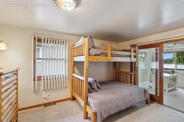 13953 Grandpoint Dr, Cement City, MI 49233 - carpeted bedroom featuring baseboards and access to exterior
