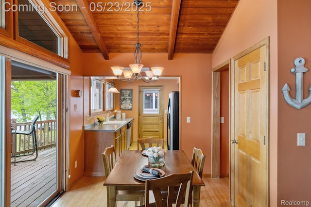 13953 Grandpoint Dr, Cement City, MI 49233 - dining area featuring wooden ceiling with exposed beams, light wood-type flooring, a chandelier, and baseboards