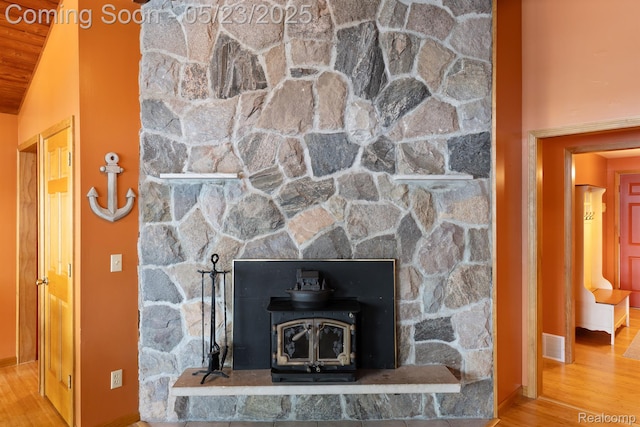 13953 Grandpoint Dr, Cement City, MI 49233 - detailed view of a wood stove, wood finished floors, and baseboards