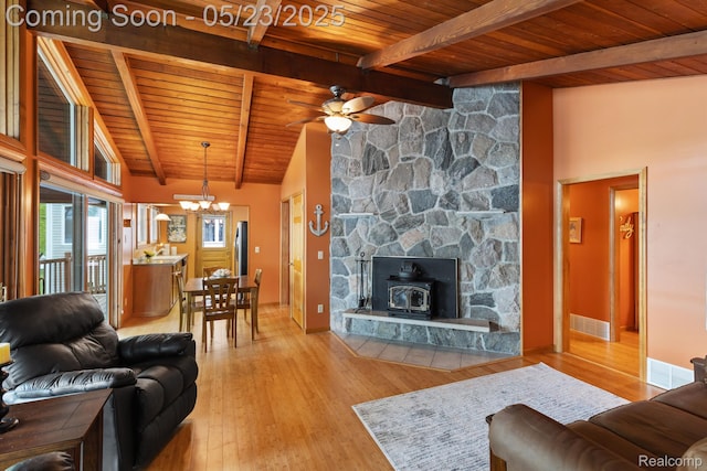 13953 Grandpoint Dr, Cement City, MI 49233 - living area with wooden ceiling with exposed beams, a wood stove, a chandelier, ceiling fan, and wood finished floors