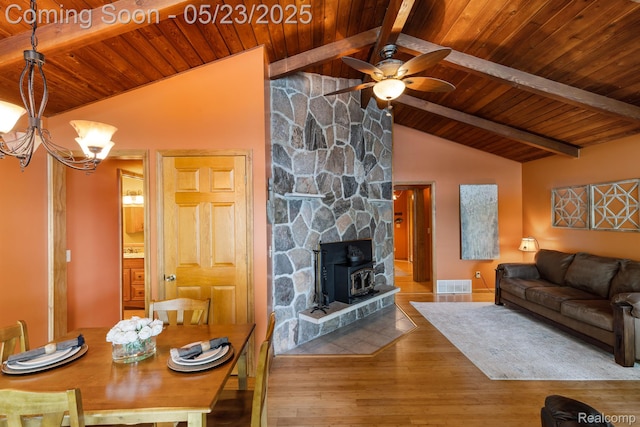 13953 Grandpoint Dr, Cement City, MI 49233 - living room featuring wooden ceiling, ceiling fan, wood finished floors, a wood stove, and a chandelier