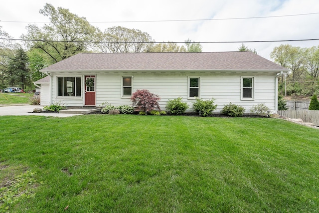 ranch-style home featuring roof with shingles