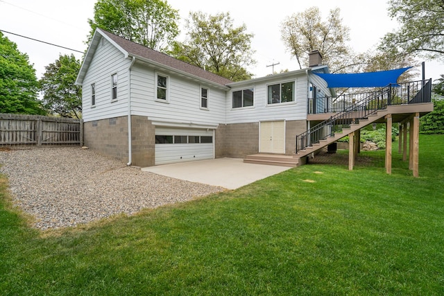 rear view of property featuring stairway, a garage, concrete driveway, a wooden deck, and a chimney