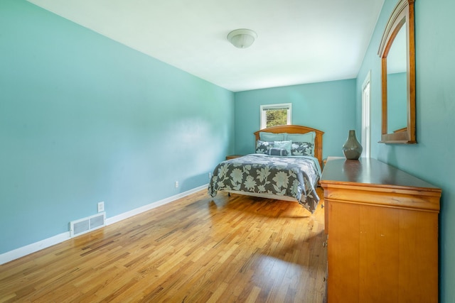 bedroom featuring wood finished floors and baseboards