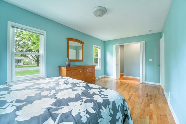 bedroom with wood finished floors and baseboards