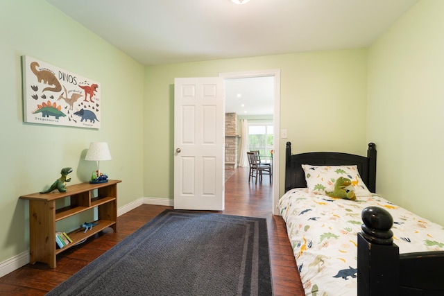 bedroom with wood finished floors and baseboards