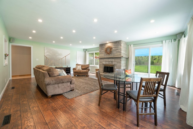 dining room featuring a fireplace, hardwood / wood-style floors, plenty of natural light, recessed lighting, and baseboards