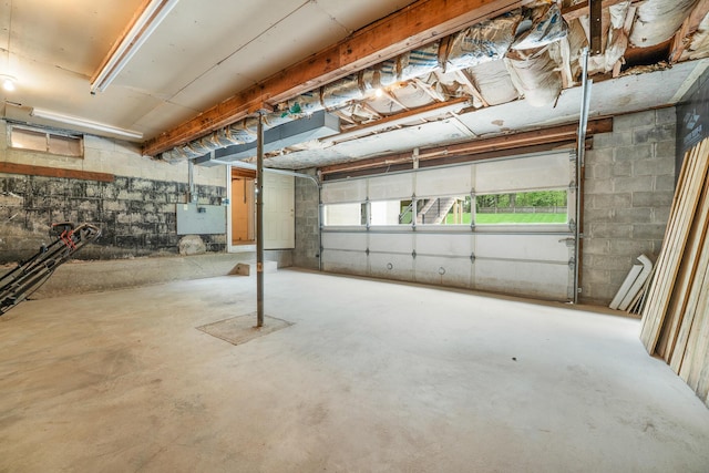below grade area featuring a garage and concrete block wall