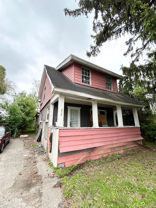 2317 Flushing Rd, Flint, MI 48504 - view of front of home with covered porch, asphalt driveway, and a shingled roof