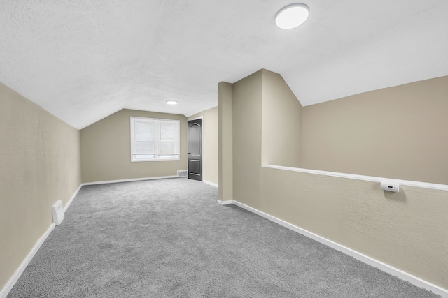 9583 Stahelin Ave, Detroit, MI 48228 - additional living space with lofted ceiling, baseboards, and carpet