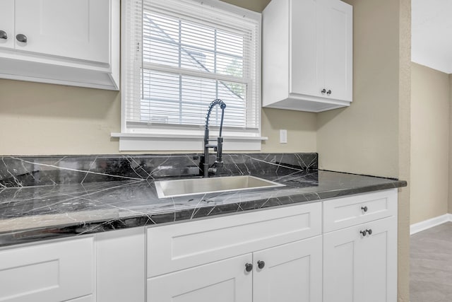 9583 Stahelin Ave, Detroit, MI 48228 - kitchen featuring a sink, dark countertops, and white cabinets