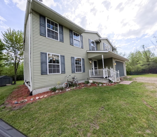 5734 108th Ave, Pullman, MI 49450 - view of front of house featuring a front lawn, an attached garage, covered porch, and driveway