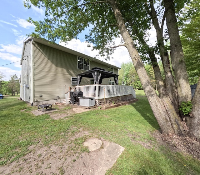 5734 108th Ave, Pullman, MI 49450 - rear view of property with a deck, an outdoor fire pit, and a lawn