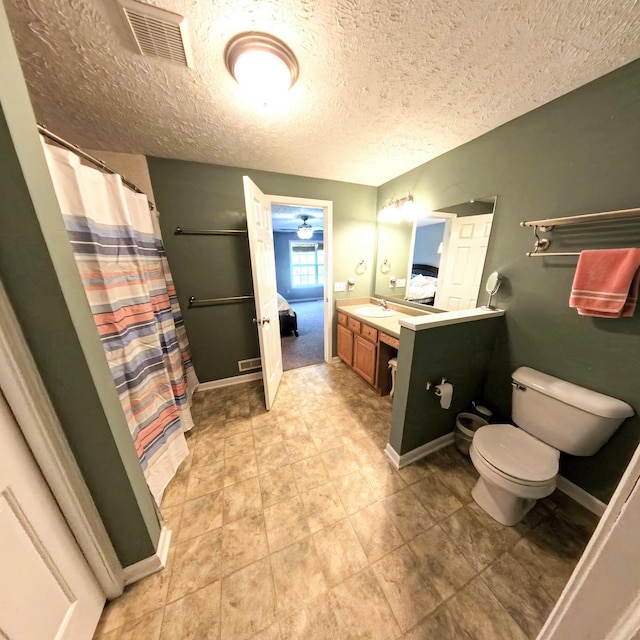 5734 108th Ave, Pullman, MI 49450 - bathroom featuring toilet, vanity, a textured ceiling, baseboards, and a shower with shower curtain