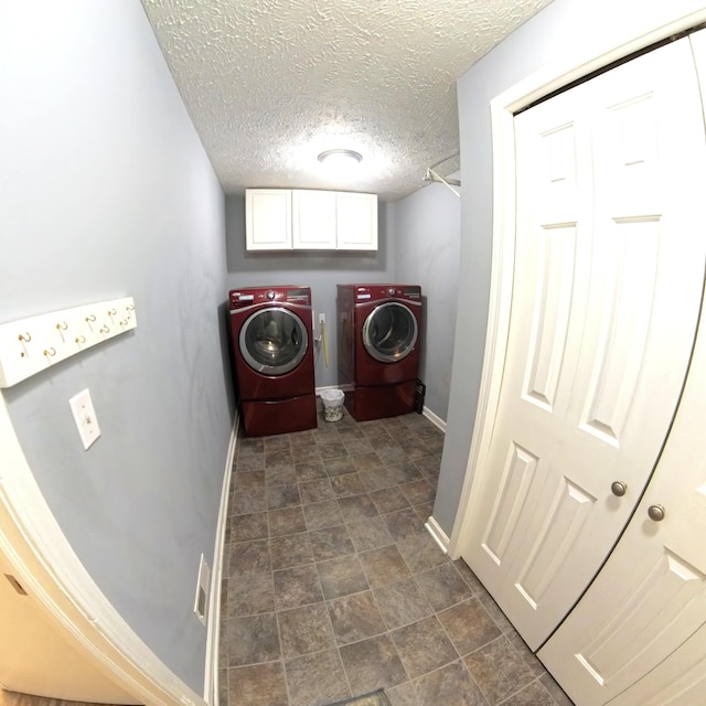 5734 108th Ave, Pullman, MI 49450 - laundry room with baseboards, washing machine and clothes dryer, cabinet space, a textured ceiling, and stone finish floors
