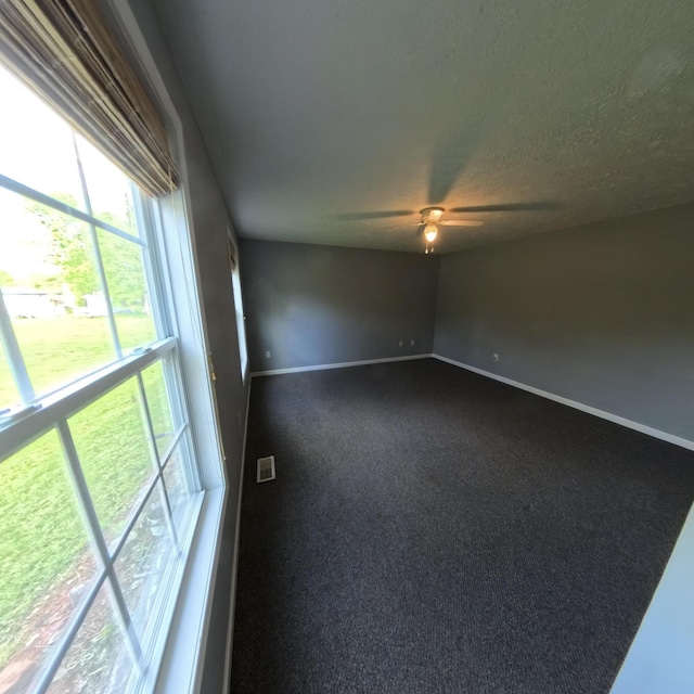 5734 108th Ave, Pullman, MI 49450 - empty room featuring a ceiling fan, baseboards, and dark carpet