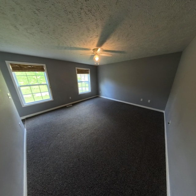 5734 108th Ave, Pullman, MI 49450 - spare room featuring a textured ceiling, a ceiling fan, baseboards, and dark carpet
