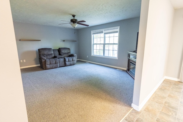5734 108th Ave, Pullman, MI 49450 - unfurnished room featuring ceiling fan, light carpet, a glass covered fireplace, and a textured ceiling