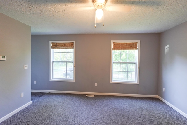 5734 108th Ave, Pullman, MI 49450 - spare room with a textured ceiling, dark colored carpet, and ceiling fan