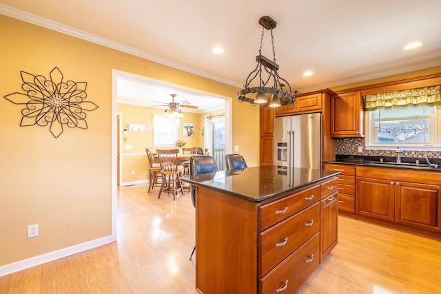 1719 Center St, Carleton, MI 48117 - kitchen with high end fridge, a sink, a kitchen island, ornamental molding, and light wood finished floors