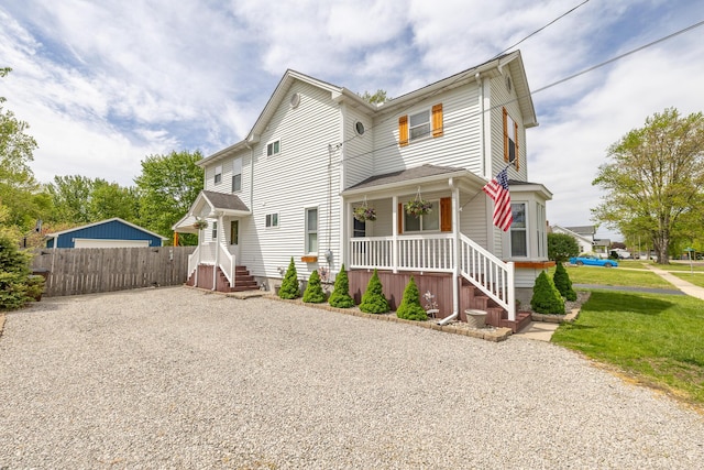 1719 Center St, Carleton, MI 48117 - view of front facade featuring covered porch, driveway, and fence