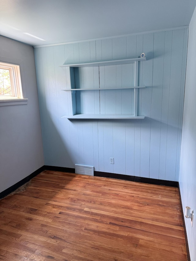 unfurnished room featuring wood finished floors and baseboards
