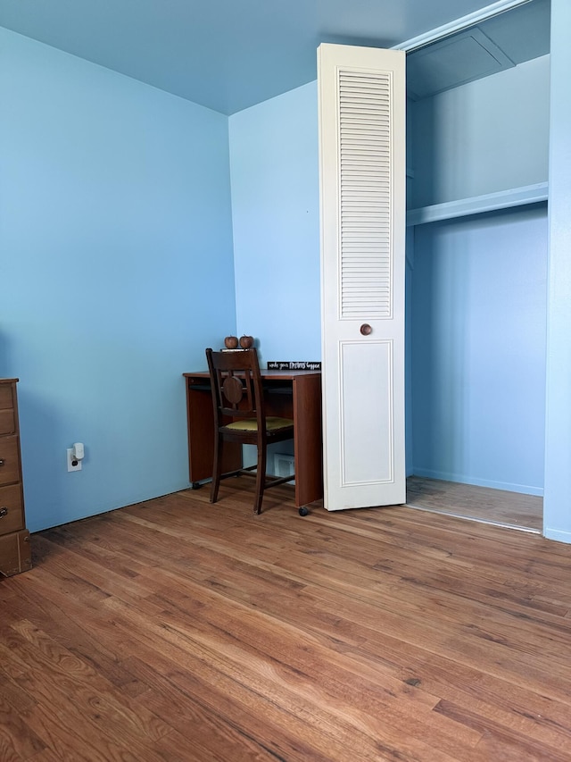 unfurnished office featuring wood finished floors