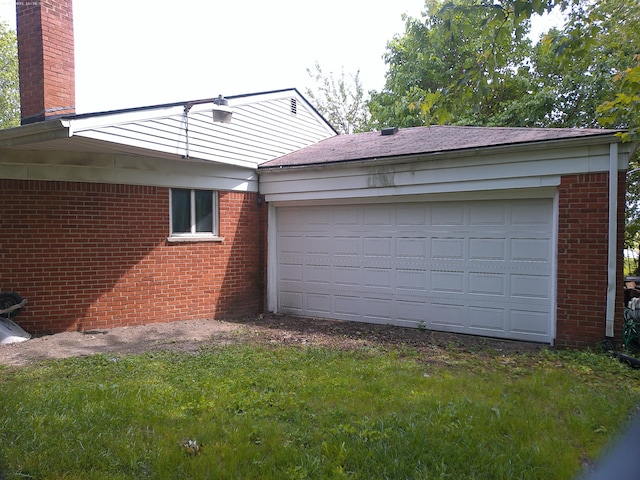 21423 Scotia Ln, Ferndale, MI 48220 - view of home's exterior with brick siding, a chimney, a garage, and a yard