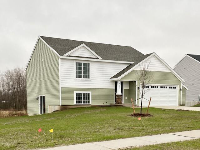 LOT146 Butternut Dr, Wayland, MI 49348 - view of front facade featuring a garage, driveway, and a front lawn