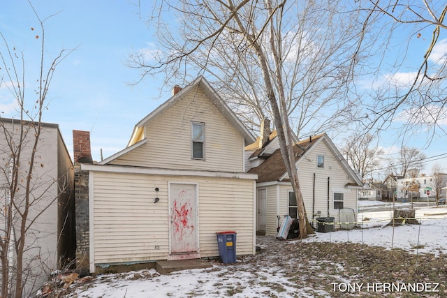 1402 N Ave NE, Grand Rapids, MI 49505 - snow covered rear of property featuring a chimney