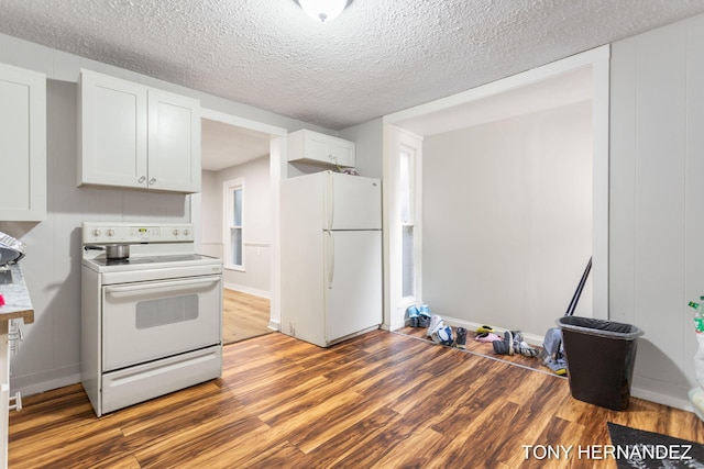 1402 N Ave NE, Grand Rapids, MI 49505 - kitchen featuring white appliances, wood finished floors, white cabinets, a textured ceiling, and baseboards