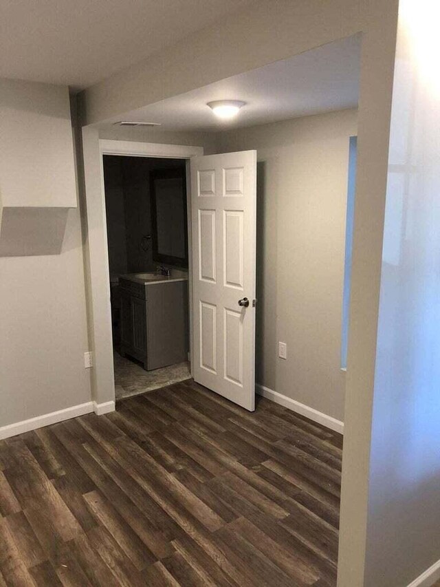 1402 N Ave NE, Grand Rapids, MI 49505 - unfurnished room featuring dark wood-type flooring and baseboards