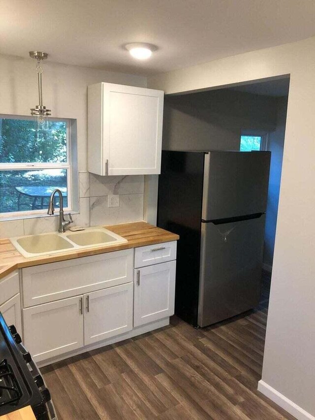 1402 N Ave NE, Grand Rapids, MI 49505 - kitchen featuring freestanding refrigerator, a sink, white cabinetry, and dark wood-style floors
