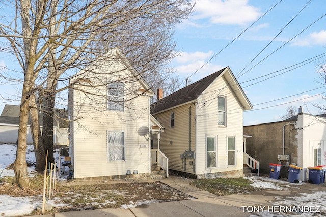 1402 N Ave NE, Grand Rapids, MI 49505 - snow covered rear of property featuring entry steps