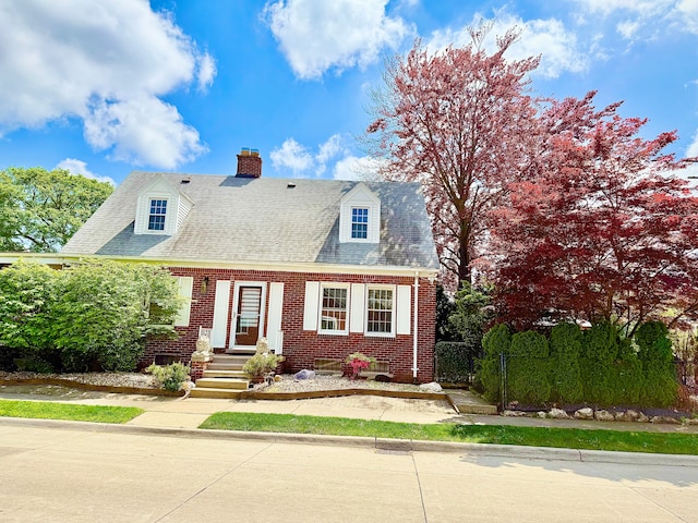 4775 Orchard Ave, Dearborn, MI 48126 - cape cod-style house featuring brick siding, a chimney, and fence