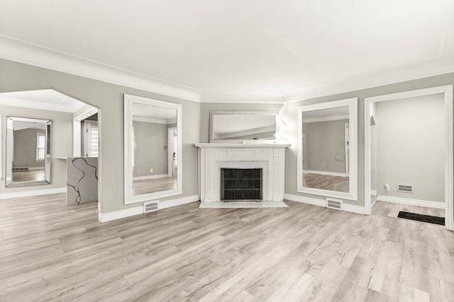 4775 Orchard Ave, Dearborn, MI 48126 - unfurnished living room featuring light wood-style flooring, ornamental molding, a fireplace with flush hearth, baseboards, and arched walkways