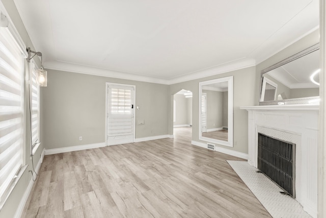 4775 Orchard Ave, Dearborn, MI 48126 - unfurnished living room featuring light wood-style floors, arched walkways, a fireplace with flush hearth, ornamental molding, and baseboards