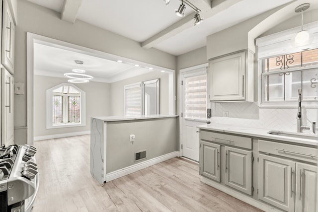 4775 Orchard Ave, Dearborn, MI 48126 - kitchen featuring a sink, light countertops, stainless steel range with gas stovetop, light wood-style flooring, and a chandelier