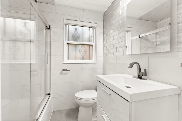 4775 Orchard Ave, Dearborn, MI 48126 - full bath with tile walls, toilet, vanity, and bath / shower combo with glass door
