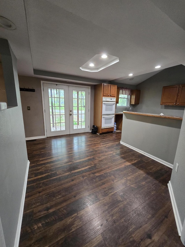3800 W Hallett Rd, Hillsdale, MI 49242 - unfurnished living room with baseboards, dark wood-style floors, recessed lighting, french doors, and a tray ceiling