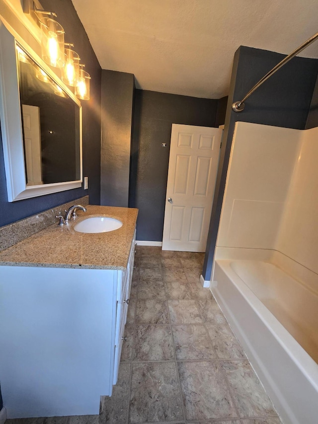 3800 W Hallett Rd, Hillsdale, MI 49242 - bathroom with vanity, shower / bathtub combination, and baseboards