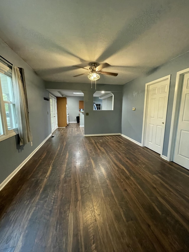 3800 W Hallett Rd, Hillsdale, MI 49242 - unfurnished living room featuring wood-type flooring, a ceiling fan, a textured ceiling, and baseboards