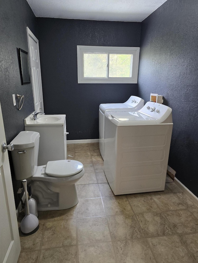 3800 W Hallett Rd, Hillsdale, MI 49242 - clothes washing area featuring separate washer and dryer, a textured wall, and baseboards