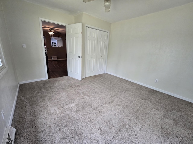 3800 W Hallett Rd, Hillsdale, MI 49242 - unfurnished bedroom featuring carpet floors, baseboards, a closet, and ceiling fan