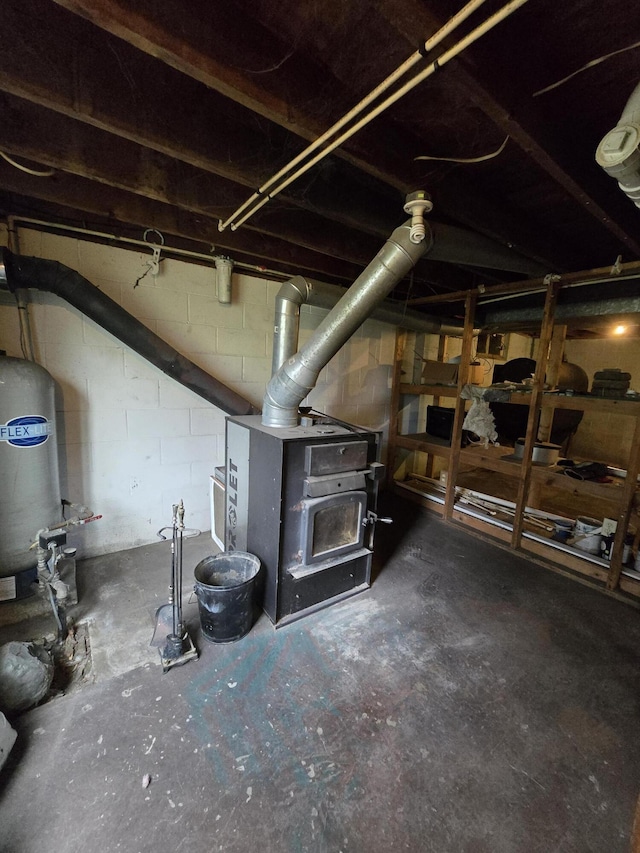 3800 W Hallett Rd, Hillsdale, MI 49242 - unfinished below grade area featuring concrete block wall and a water pressure tank